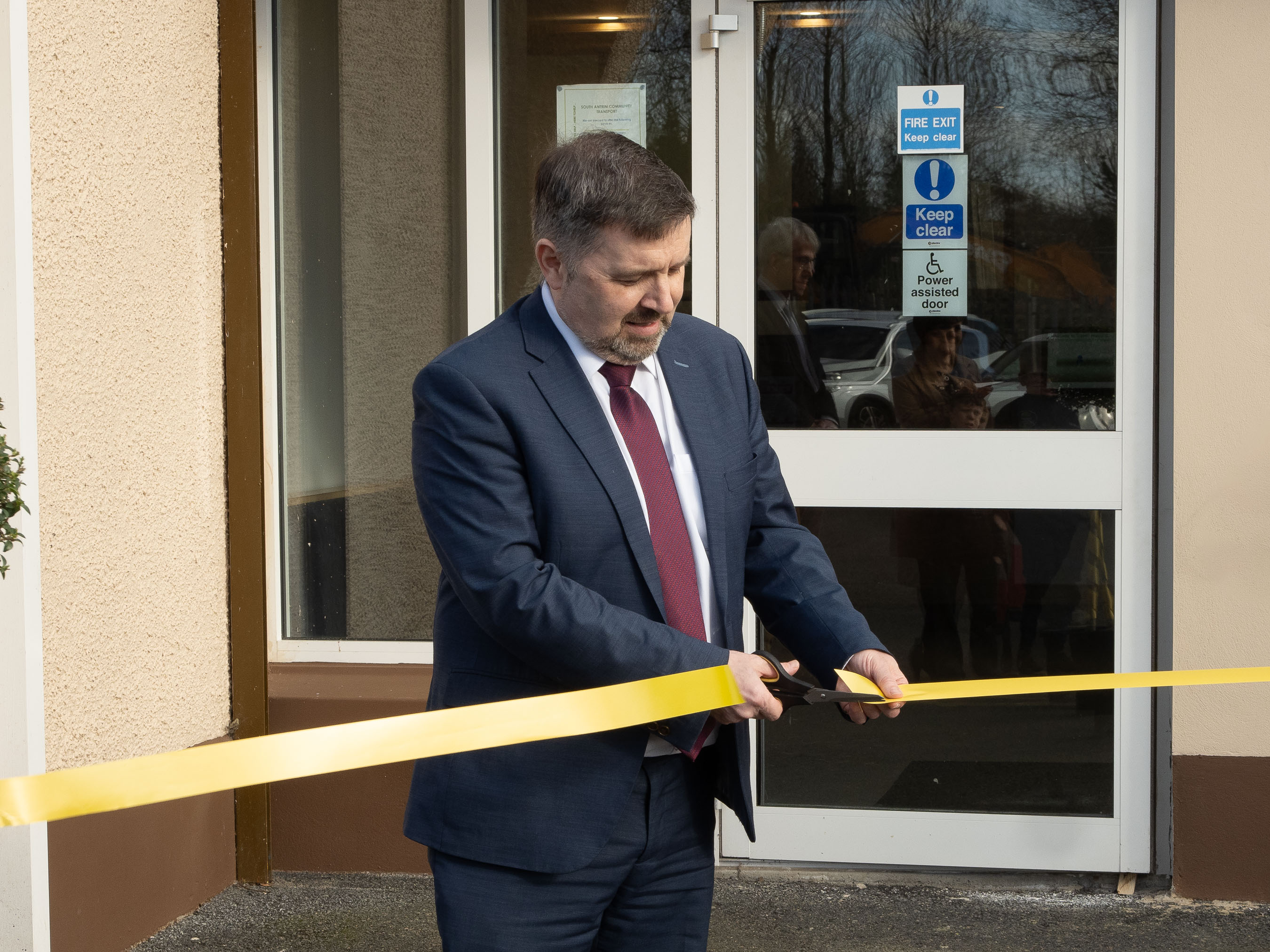 Health Minister Robin Swann cutting the ribbon at the opening of the newly renovated Toome Surgery