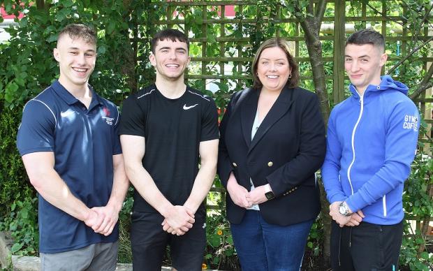 Communities Minister Deirdre Hargey is pictured with gymnasts (l-r) Ewan McAteer, Eamon Montgomery and Rhys McClenaghan