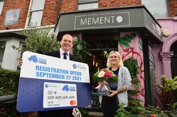 Economy Minister Gordon Lyons pictured with Milana Surova of Memento florists on the Ormeau Road, Belfast.