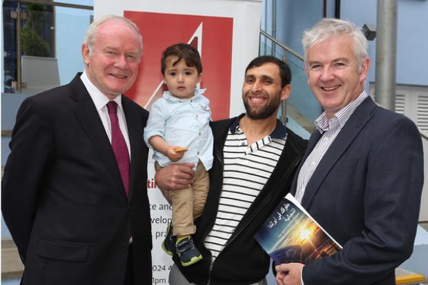 The deputy First Minister, Martin McGuinness and Glenn Jordan,Director, Law Centre (NI), with Syrian refugees Sorani Mohamed and son, Nouraedin (14 months)