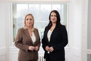 Image of two people standing in front of a window